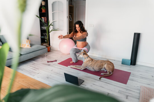 Pregnant woman doing prenatal strenght exercises at home