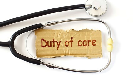 A stethoscope rests upon a note reading duty of care clearly