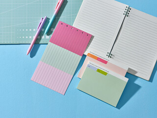 Colorful stationery and notebook on a blue background