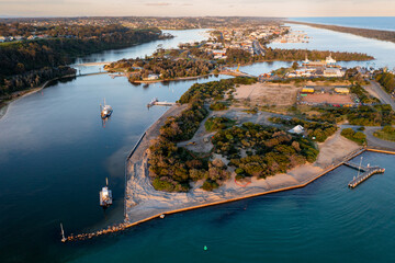 An island and town surrounded by water along a flat coastline