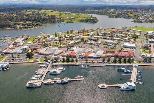 Boats and watercraft moored at a harbor of a coastal town