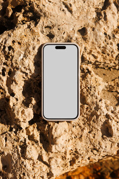 Phone with White Screen on Rock Surface Mockup