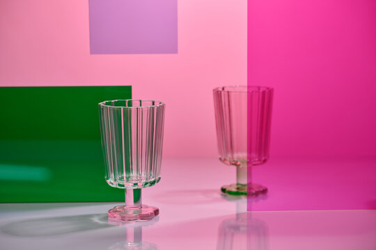 Stylish clear glasses are set against a backdrop of vibrant