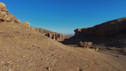 A drone rises smoothly from the bottom of the Charyn Canyon, revealing its grandeur. Charyn, Kazakhstan. 07.01.26