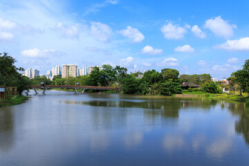 Panorama view with Moonrise Bridge connecting Chinese Garden and Japanese Garden in Jurong Lake Gardens and apartment towers, Singapore