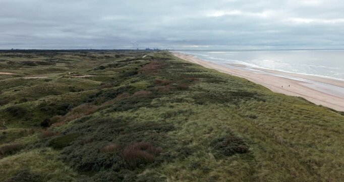 calm ocean coastline with green dune egmond aan zee north sea
