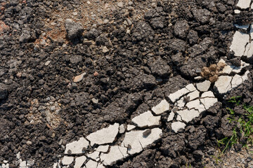 Detailed cracked asphalt surface showing broken road texture pattern useful for infrastructure damage reference construction material study erosion impact surface detail rugged ground structure