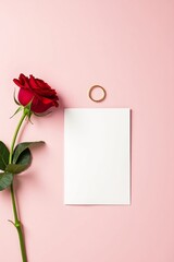 Valentine's Day flat lay with red rose and blank card.