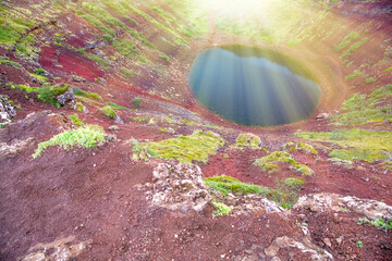 Icelandic Kerid crater lake surrounded by volcanic terrain on a summer day