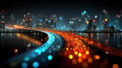 Busy highway at night with city skyline and colorful light trails from moving cars