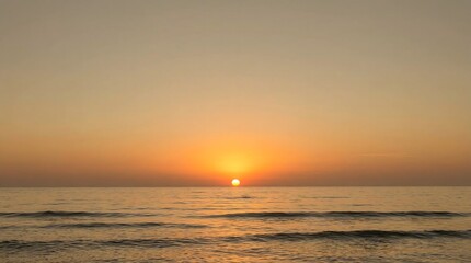 Fototapeta premium Minimalist ocean sunset with warm golden colors and gentle waves, creating a relaxing and peaceful seascape background.Keywords