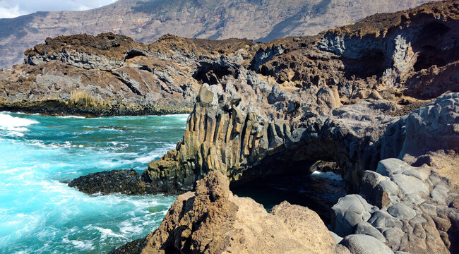Coastline displaying volcanic rock formations and ocean waves, Valley of El Golfo, Island El Hierro, Canary Islands, Spain, Europe.