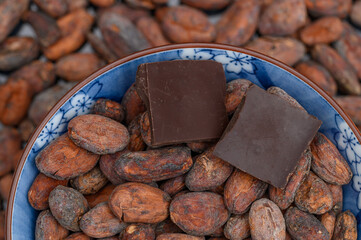 Bitter dark chocolate cubes embedded in real cocoa beans