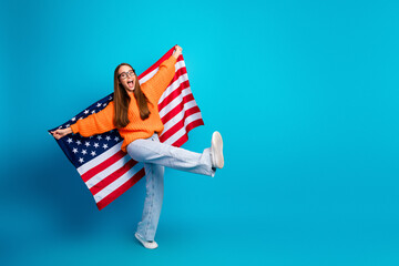 Young woman with American flag happy playful jumper lifestyle fashion model posing indoors against...