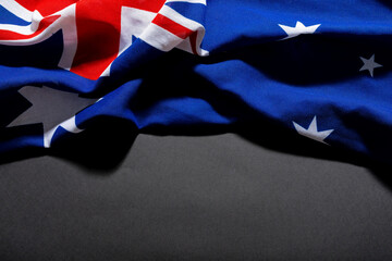 British union jack along with stars on australia flag on black table and copy space