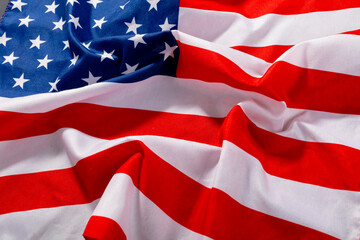 Obraz premium Full frame of red and white stripes along with stars on crumpled america flag