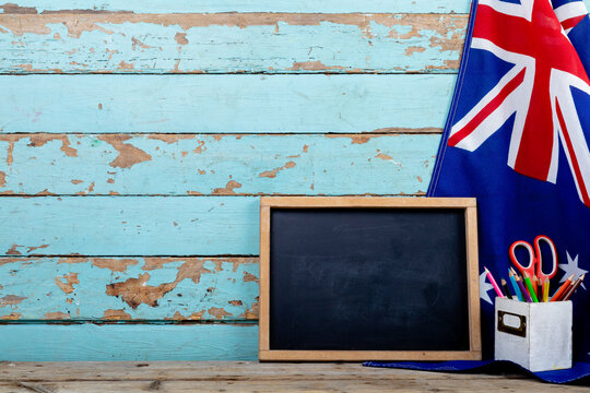 Blank writing slate with copy space by desk organizer on australia flag over table