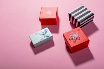 High angle view of multi colored valentine present boxes on pink background with copy space