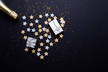 Valentine presents on stars arranged as heart shape by champagne bottle by copy space