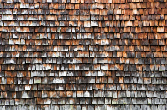 Detail of weathered wood shingle farmhouse facade in Stuebing Austria