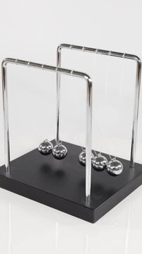 Vertical View of Newton's Cradle Metal Spheres in Motion