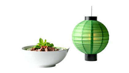 A bowl of Vietnamese soup and a decorative green lantern against a black background. Simple yet elegant