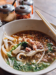 Thai Spicy Fish Noodle Soup served in a bowl.