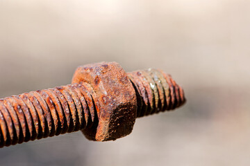 rusty nut. Rusty iron rod with screw threads. Rusted mechanical components. threaded bolt and nut isolated close up. dismantling concept, difficult to unscrew, non-removable. selective focus