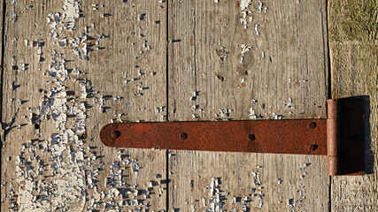 old padlock. Closeup view of an old padlock covered in rust, attached to a cracked wooden door. It represents themes of security, the passage of time, decay, and vintage aesthetics. the door is locked