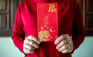 Red envelope, Red packet, Hands holding Hong Bao hongbao for giving, Angpao with gold Fu symbol,...