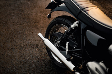 Powerful sleek black motorcycle rear view with gleaming chrome details, perfect for automotive, travel, and lifestyle projects.