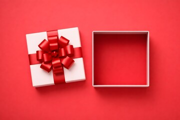 White gift box with satin bow beside open container on red studio backdrop
