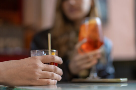 Close up of hands holding cocktails at social cafe gathering - Powered by Adobe
