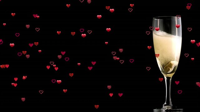 Animation of falling hearts over glass of champagne on red background