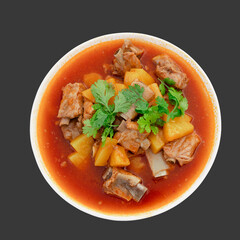 baked pork ribs with pineapple on white plate isolated on grey background including clipping path, top view