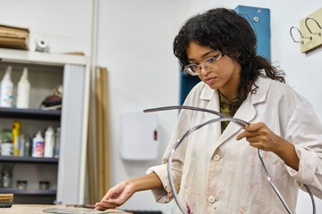 Woman artist creating art in a workshop studio