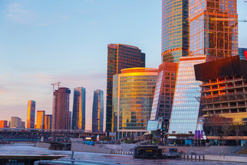 High-rise buildings of the Moscow City business center on the banks of the Moskva River at dawn.
