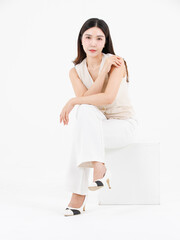 Portrait of attractive asian professional cheerful beautiful young woman in business work shirt style long black hair smile sitting posing happy confident positive on isolate white background studio.