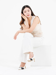 Portrait of attractive asian professional cheerful beautiful young woman in business work shirt style long black hair smile sitting posing happy confident positive on isolate white background studio.