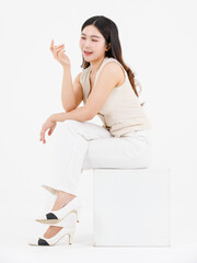 Portrait of attractive asian professional cheerful beautiful young woman in business work shirt style long black hair smile sitting posing happy confident positive on isolate white background studio.