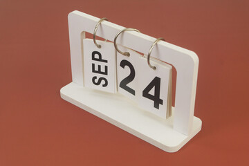 September 24 on calendar on brown background