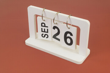 September 26 on calendar on brown background