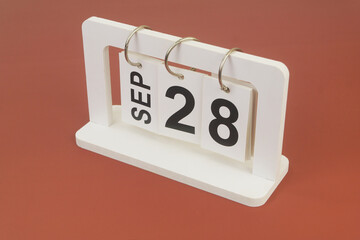 September 28 on calendar on brown background