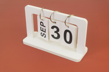 September 30 on calendar on brown background