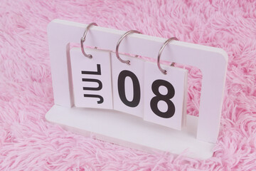 July 8 on calendar on pink carpet background