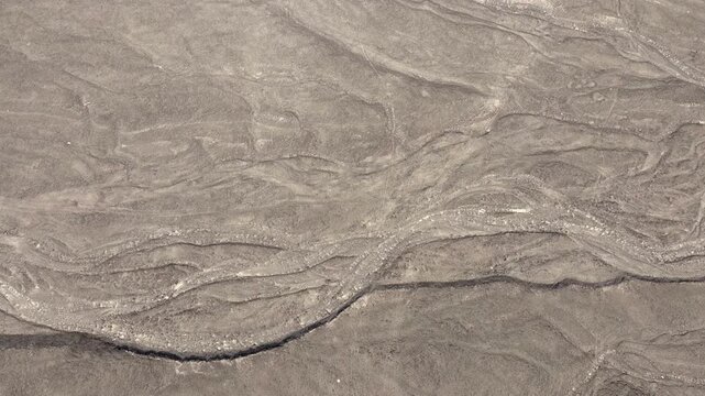 Desert from above with erosion and structures. AERIAL, Peru