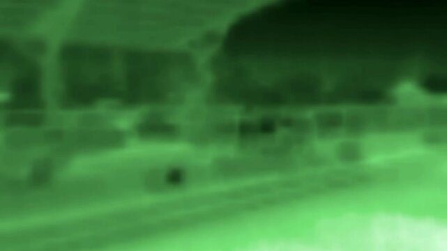 The train arrives at the station platform. Shooting from the window. Image from thermal imager device.
