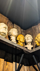 Clay Classical Heads in Sculptor's Workshop on Wooden Shelf. Aesthetic Artistic Mood Background
