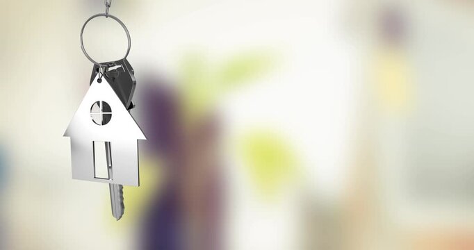 A key chain and plant adorn a creative office desk against a green screen.