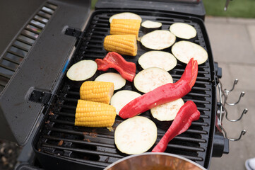 Grilled vegetables: corn, eggplant, and red peppers on barbecue grill